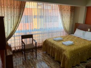 Postel nebo postele na pokoji v ubytování Sumaq Hotel Tacna
