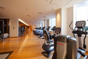 a gym with a row of treadmills and ellipticals at ANA InterContinental Tokyo by IHG in Tokyo