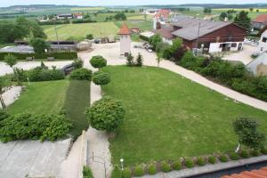 an aerial view of a green park with a church at Landhotel zur Kanne in Neresheim