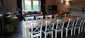 a living room with a wooden table and chairs at B&B de Remketting in Slijk-Ewijk