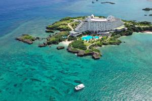 an aerial view of a hotel on a island in the ocean at ANA InterContinental Manza Beach Resort by IHG in Onna