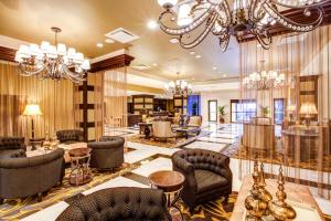 a lobby with chandeliers and chairs and a salon at InterContinental New Orleans by IHG in New Orleans