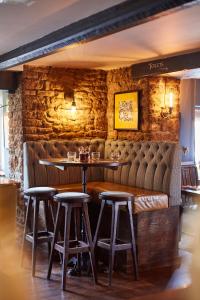
a dining room with a wooden table and chairs at The Swan Inn in Winscombe
