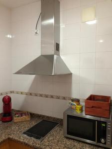 Kuchyň nebo kuchyňský kout v ubytování Apartamento Ocuri