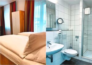 ein Bad mit einem Bett, einem Waschbecken und einem WC in der Unterkunft DONAUHOTEL Ingolstadt in Ingolstadt