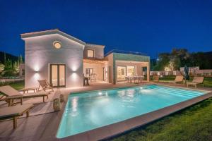 The swimming pool at or close to Ionian Trilogy Luxury Villas