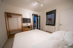 A bed or beds in a room at Ionian Trilogy Luxury Villas