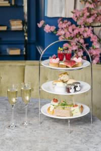 two plates of food and two glasses of wine at voco Grand Central Glasgow by IHG in Glasgow
