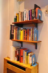 a book shelf filled with books on a wall at Pergamos Hotel in Athens