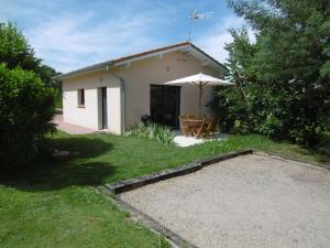 Casa pequeña con patio y sombrilla en Le BrenSol, en Brens