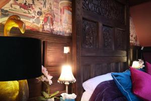 a bedroom with a bed with a wooden head board at Brockley Hall Hotel in Saltburn-by-the-Sea