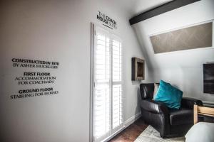 a living room with a chair and a window at Leaside Hotel in Luton