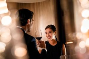 a man and a woman holding a glass of wine at ANA InterContinental Tokyo, an IHG Hotel in Tokyo