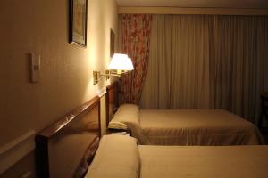 Katil atau katil-katil dalam bilik di Premier Hill Suites Hotel