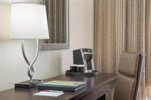 a desk with a computer and a lamp on it at Crowne Plaza Greenville, an IHG Hotel in Greenville