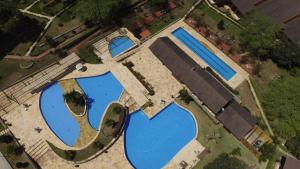 an overhead view of two large blue ponds at Winterville Flat 213 in Gravatá