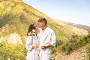 a man and a woman standing next to each other at Gibbston Valley Lodge and Spa in Queenstown