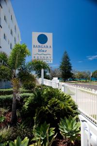 a sign for the ragnarosa blue beach hotel at Bargara Blue Resort in Bargara