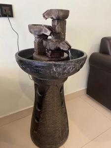 a stone fountain in the middle of a room at STAR MOON HOTEL in Bintulu