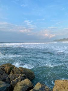 a view of the ocean with rocks in the water at Vista Las Olas Resort in El Cuco