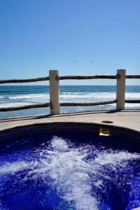 a large body of water with a blue sky at Vista Las Olas Surf Resort in El Cuco