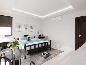 a bedroom with a bed and a glass table at Luna Oriental in Phú Quốc