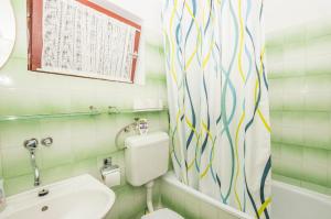 a bathroom with a toilet and a sink at Apartments Green Street in Batalaži +20 photos