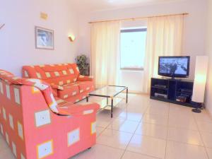 a living room with a couch and a tv at Villa Rupert - 3 Bedrooms private pool WIFI AC in Tías