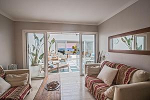 a living room with a couch and a table at Villa Fig Tree Bay Seafront Luxury 5BDR Seafront Protaras Villa with Panoramic Sea Views in Protaras