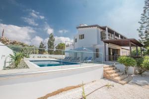 a white house with a swimming pool in front of it at Villa Nepou - Beautiful 4 Bedroom Villa - Located in Ayia Napa Villa With Private Pool in Ayia Napa