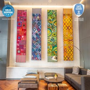a row of colorful quilts on a wall at Hyatt Centric Guatemala City in Guatemala