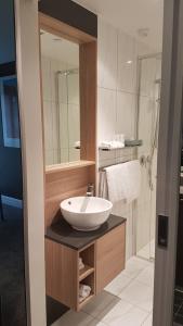 a bathroom with a sink and a mirror at Quest East Melbourne in Melbourne