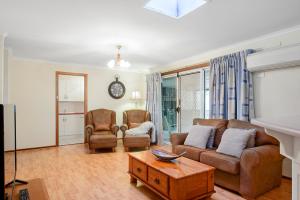 a living room filled with furniture and a large window at Moonta Bay Accommodation in Port Moonta
