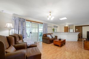 a living room filled with furniture and a tv at Moonta Bay Accommodation in Port Moonta
