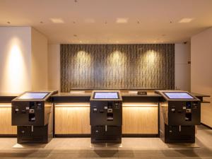 a bar in a hotel with three atm machines at Hotel Keihan Kyoto Ekiminami in Kyoto