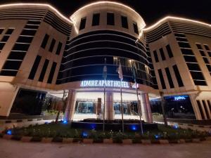 a building with a sign on it at night at Admire Apart' Hotel in Riyadh