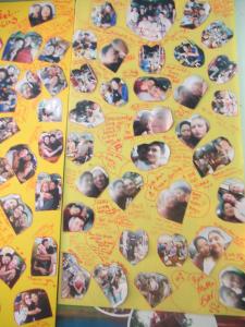 a collage of pictures of people on a yellow wall at Jay Guesthouse and Restaurant (adult only) in Chiang Mai