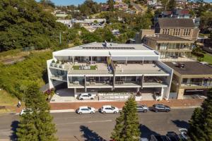 an aerial view of a building with cars parked in a parking lot at CENTRAL NO 5 LUXURY APARTMENT in Kiama
