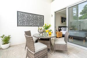 a dining room with a table and chairs at CENTRAL NO 5 LUXURY APARTMENT in Kiama