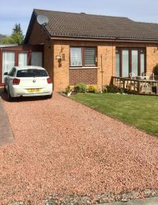 a white car parked in front of a house at Tweedbank in Galashiels
