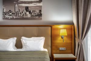 Postel nebo postele na pokoji v ubytování CITYHOTEL