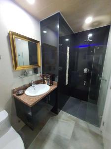 a bathroom with a sink and a shower at Kandi Palace in Angeles