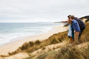 two people standing on a hill near a beach at RACV Inverloch Resort in Inverloch
