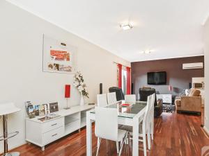 a dining room and living room with a table and chairs at McLaren Vale Studio Apartments in McLaren Vale