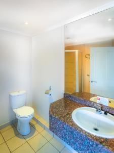 a bathroom with a toilet and a sink at Florida Park Hotel, Florida Road in Durban