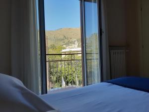 a bedroom with a bed and a large window at Hotel Esperia in Genoa