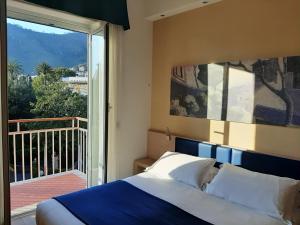 a bedroom with a bed and a large window at Hotel Esperia in Genoa