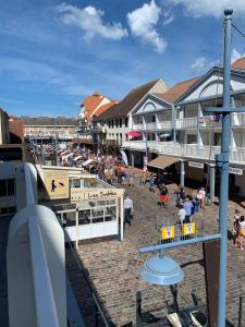 un gruppo di persone seduti sulla spiaggia di fronte agli edifici di Appartement familial plein centre Hardelot Plage a Hardelot-Plage