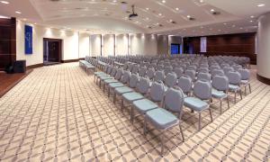 a room with rows of chairs in a hall at Hapimag Sea Garden Resort in Yaliciftlik