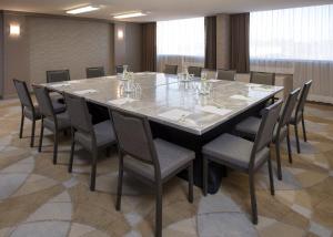 a conference room with a large table and chairs at Holiday Inn Winnipeg-South, an IHG Hotel in Winnipeg